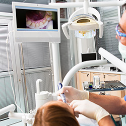 Woman and dentist looking at intraoral photos