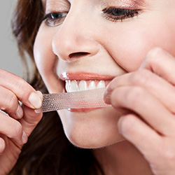 Patient placing whitening strip