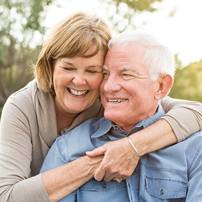 Senior couple smiling together outdoors