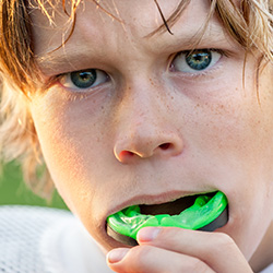 Preteen boy placing athletic sportsguard