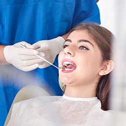 Woman receiving oral cancer screening