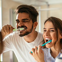 Couple brushing teeth together