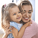 Mother and daughter smiling together