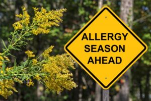 Sign reading "allergy season ahead." 